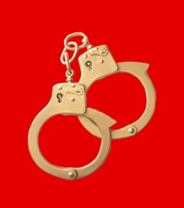 golden handcuffs on red background
